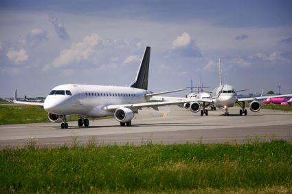 An image of aircraft lining up for takeoff at an airport. An image of aircraft lining up for takeoff at an airport.
