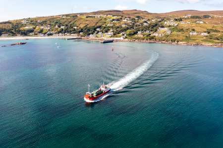 An image of a ferry leaving an island port.