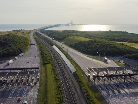 An image of a tollway, a railway line and a bridge