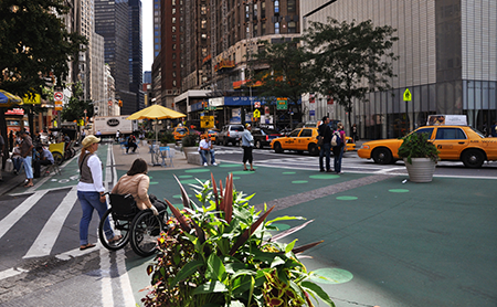 A wheelchair user crosses the street