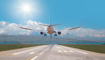 Airplane landing with mountains in the background