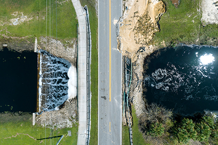 An image of a flood-damaged road